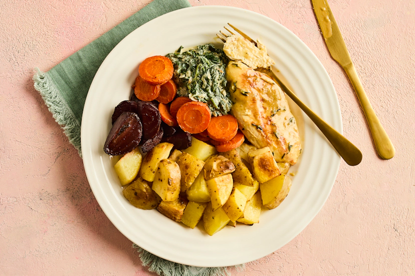 It’s chicken tonight, but with a little added ‘je ne sais quoiʼ. Searing then simmering chicken breasts in a garlic, lemon and thyme stock keeps them beautifully tender and juicy, and they’re divine served with roasted carrots, beetroot and potatoes and our lightened-up take on creamed spinach. Bon appétit!