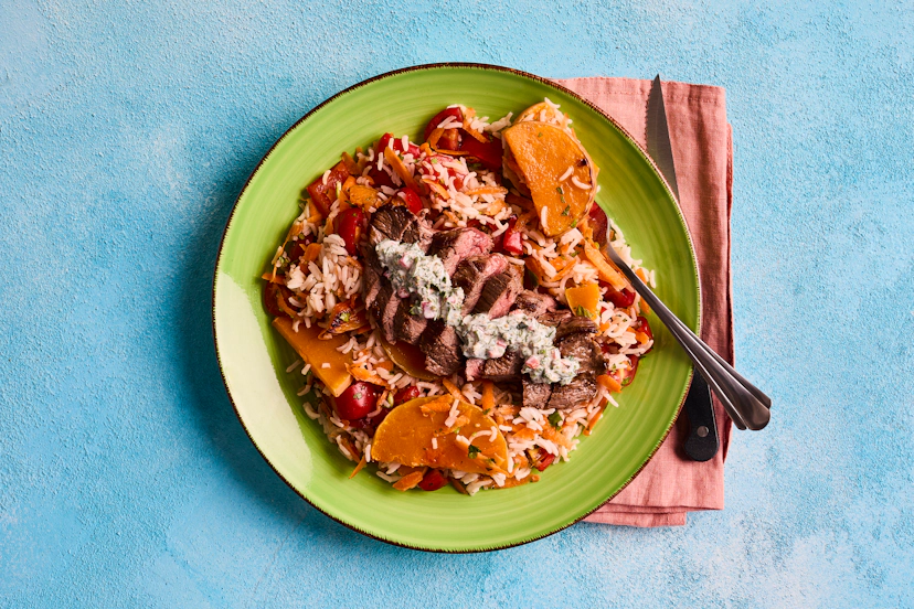 Bring the flavours of South America to your kitchen with this delicious Argentine-inspired dressing – yogurt mixed with parsley, oregano, chilli and garlic. It adds freshness and zing to fast-fried bavette steak, served with a hearty warm salad of rice, red pepper, squash, carrots, tomatoes and coriander.