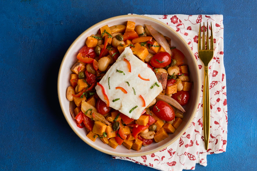 In this one-tray wonder, sweet potatoes, tomatoes, red pepper and shallots are roasted with butter beans, coated in a bold Neapolitan-inspired puttanesca-style sauce (chillies and capers add a punch!), topped with fillets of hake and scattered with basil. Mamma mia!