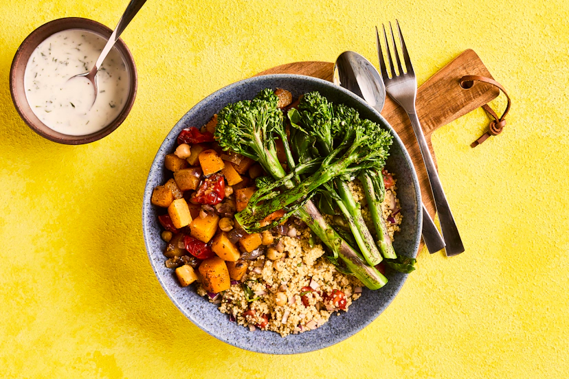 Ras el hanout is a North African spice blend, and it brings the flavours of Morocco to this super-filling traybake. Squash, chickpeas and tomatoes are oven roasted and served with a side of roasted broccoli, herby couscous and a zesty yogurt dressing.