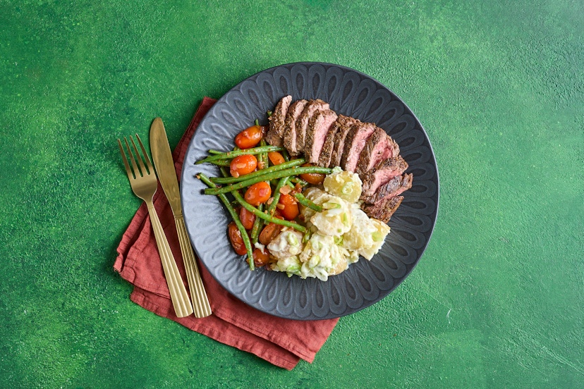 Juicy oregano-sprinkled steaks would usually be the star attraction, but in this divine dish the sides deserve the spotlight, too! There’s a quickie baby potato and spring onion salad, plus green beans get a glow-up with fried onion, garlic, sweet cherry tomatoes and a squeeze of our sun-dried tomato paste.