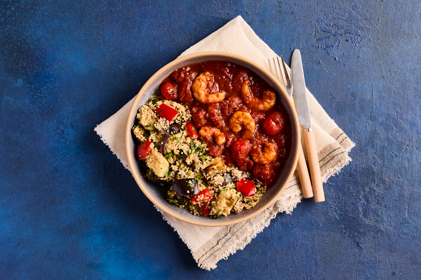 A big bowl of sunshine, this luscious prawn and tomato stew is seasoned with our special baharat spice mix – think cumin, coriander and cinnamon – and served with couscous loaded with roasted aubergine, courgette, red pepper and onion.