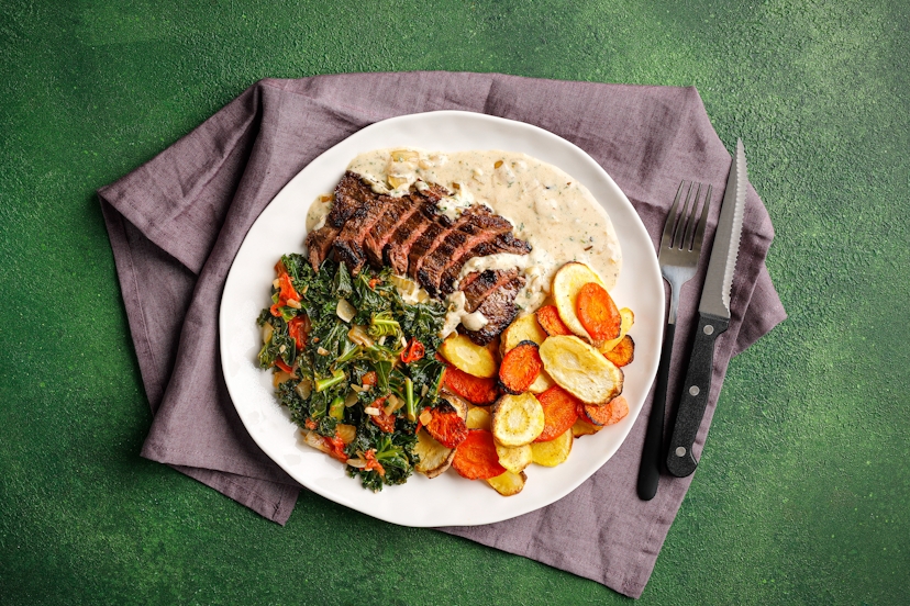 Say bonjour to your new favourite! We’re serving up tasty bavette steaks with Lyonnaise parsnips and carrots (thinly sliced then sautéed till crispy), plus a side of garlicky fried onions, tomatoes and kale. And on top of all that, the pièce de résistance – a herby yogurt drizzle.