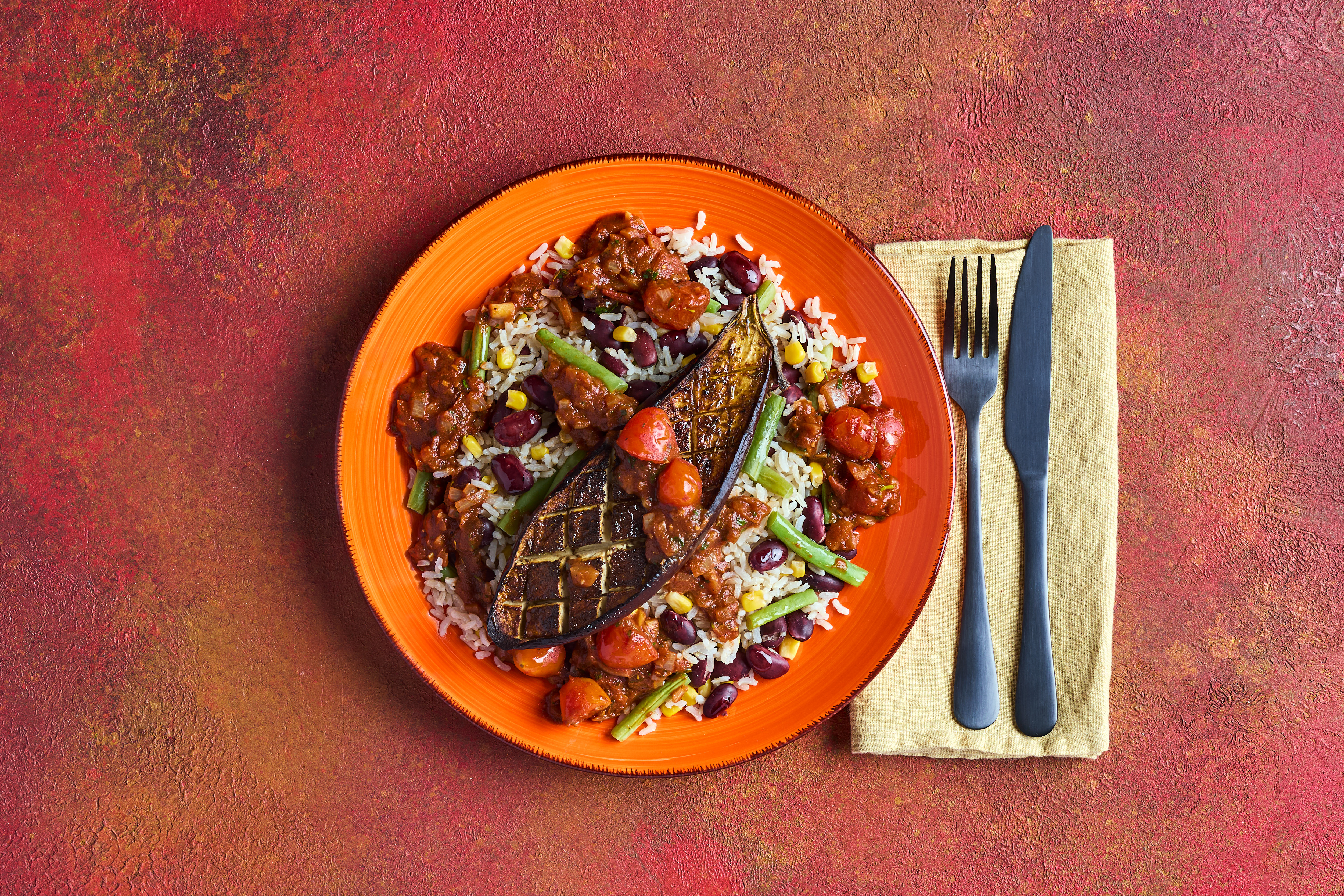 Slow-roast aubergine with rainbow rice & beans