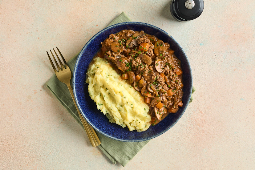 With lean beef mince, sliced chestnut mushrooms, carrot and onion, a garlicky, herby gravy, plus a side of peppy potato mash flecked with chopped chives, this homey and hearty stew will satisfy your appetite and your soul.