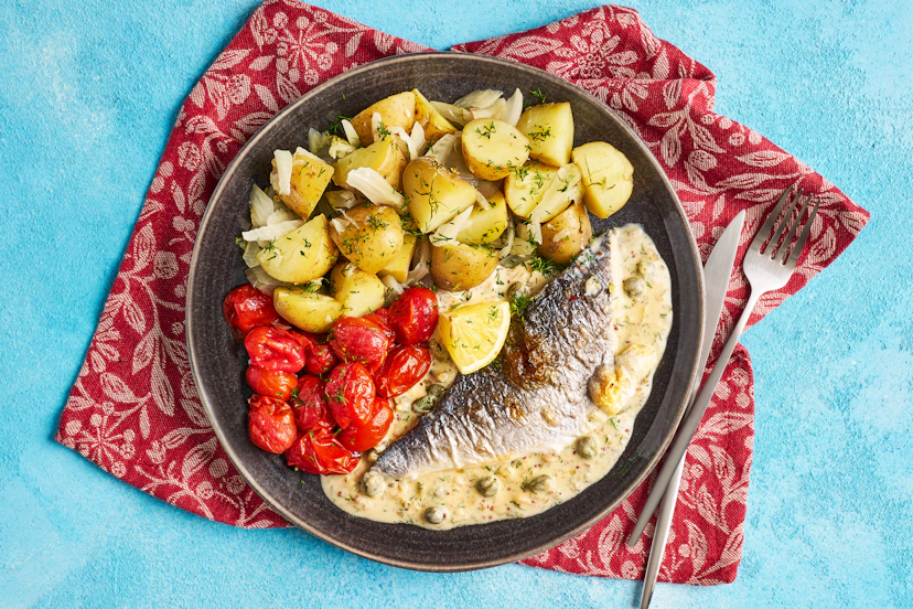 This swish fish dish has serious flair. Crispy-skinned sea bream fillets and grilled baby tomatoes are served on a creamy caper, shallot and wholegrain mustard sauce with fennel-infused baby potatoes, all scattered with fresh dill.