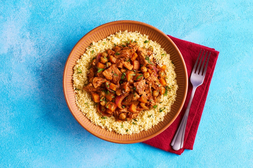 This hearty, planty tagine will put a smile on your face. Onion and carrot are softened with our Moroccan seasoning and ginger and garlic paste before jackfruit and chickpeas join the party, simmering in a rich tomato sauce stirred through with mint. A mound of fluffy couscous mops up every delicious drop.