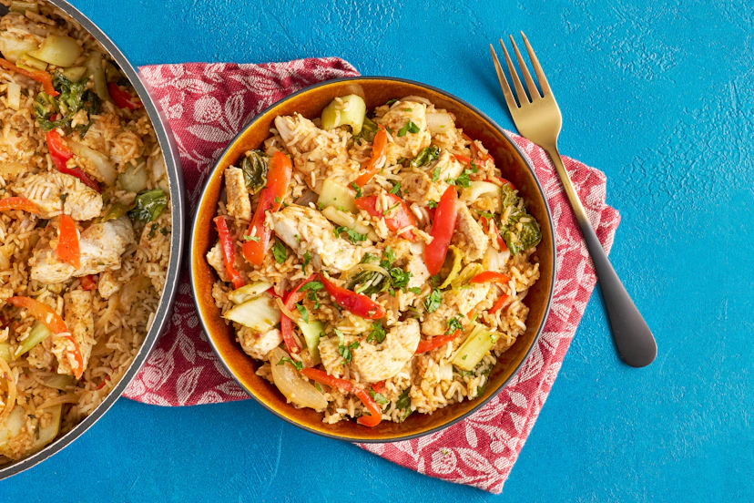 When life’s a juggle, dinner should be satisfying, smile-inducing and streamlined – not another thing on the to-do list. This fragrant one-pan feast of chicken, stir-fry veg, coriander and rice in a Thai red curry and sun-dried tomato sauce ticks every box.