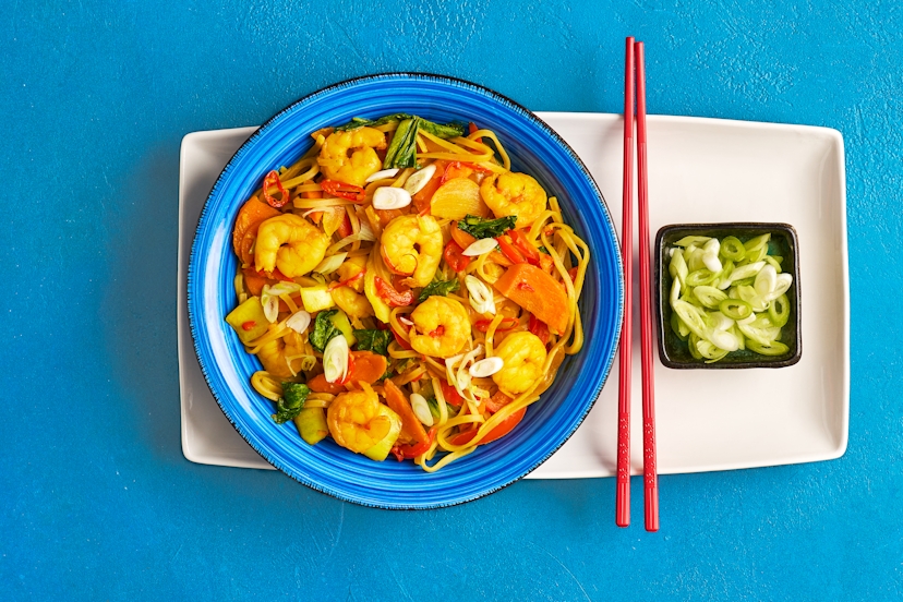A zingy blend of ginger, garlic, tamari and curry powder creates a medium-hot sauce in this takeout classic. Stir in prawns, peppers, pak choi, chillies and onions, plus noodles to soak up those flavours, and you’ve got a filling fakeaway that’ll transport your taste buds to spicy South East Asia.