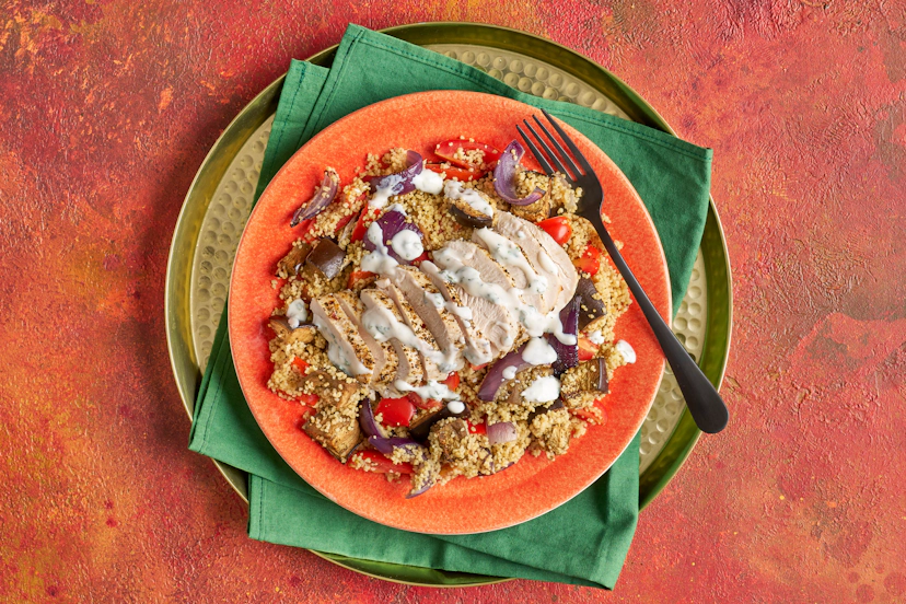 A sprinkle of magical Moroccan seasoning turns simple baked chicken breasts into something special. Fluffy couscous loaded with roasted onion, red pepper, aubergine and chopped baby tomatoes provides a tasty, satisfying base, while a drizzle of minty yogurt balances the warm spices beautifully.