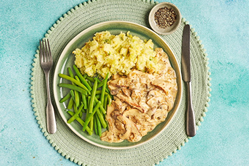 This superior comfort-food supper is a gift when your spirits need a little lift! Tender pork loin is seared and rested while you sauté shallots and mushrooms. Garlicky stock, a dash of mustard and swirl of yogurt make a silky sauce ready to smother slices of that pork – with cabbage-rich colcannon and green beans to mop up every last drop.