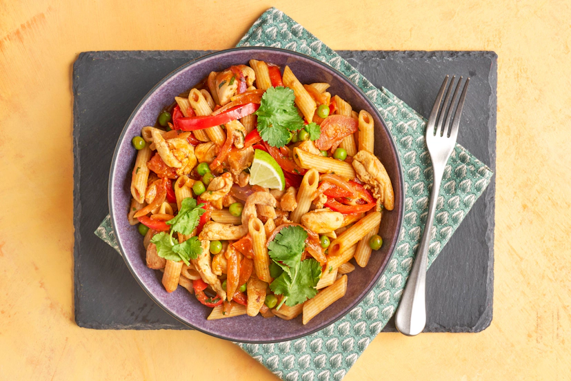 Juicy strips of chicken thigh are jumbled in a hot pan with onion, red pepper, tomatoes and peas, then tumbled with wholesome wholewheat pasta tubes and a lime-spiked peri-peri sauce. It’s fast, filling and thrilling!