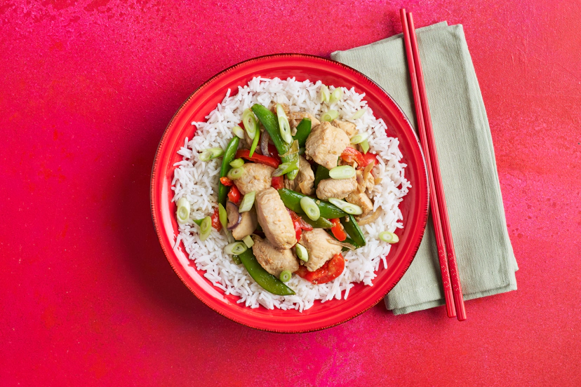 This simple stir-fry gets its delicious depth of flavour from a rather surprising ingredient… Marmite! Together with (slightly more traditional!) tamari and ginger, it quietly transforms sizzled chicken, onion, red pepper and sugar snaps into an umami-packed sensation. Served on fluffy basmati rice.