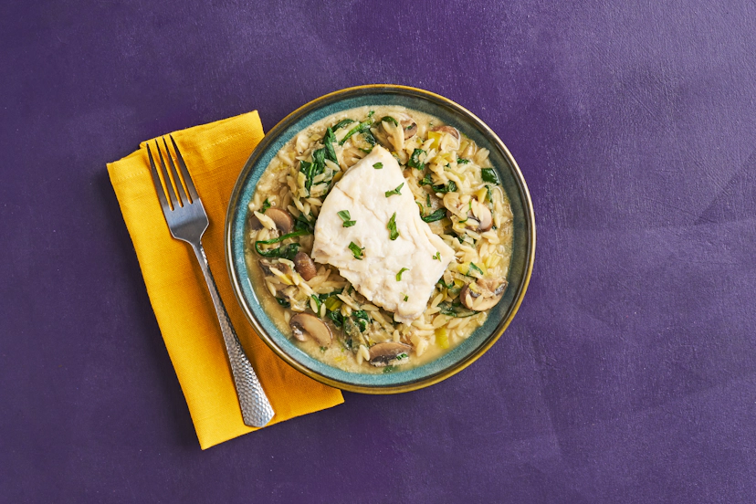 Cod almighty - this simple fish dish really delivers! While fillets are grilling and orzo pasta’s simmering, you’ll whip up a tasty base of shallot, leek and mushroom. Our easy-squeezy garlic & herb paste and a splash of stock raise the flavour stakes, blending with spinach, tarragon and a swirl of yogurt to give dinner a taste of the divine!