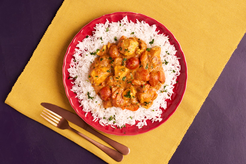 A pouch of deliciously spiced sauce and ready-diced chicken breast make light work of this crowd-pleasing curry. Just fry chopped onion, red pepper and baby toms with the chicken, sprinkle in some cumin, then simmer with the sauce. A swirl of Greek yogurt gives it that silky-smooth masala finish we all know and love. Served with basmati rice.