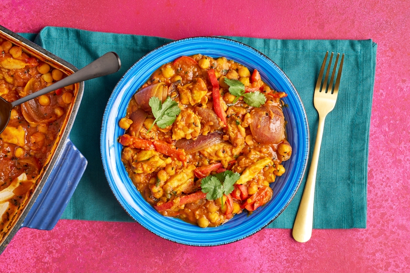 Red pepper and red onion are sprinkled with cumin and nigella seeds and roasted, then joined by juicy chicken thigh chunks, a quick curry sauce, filling chickpeas and red split lentils. It’s a hearty trayful with barely room to swing a serving spoon – even fresh coriander squeezes on at the end like it’s the last train home. Hey, the more the merrier!