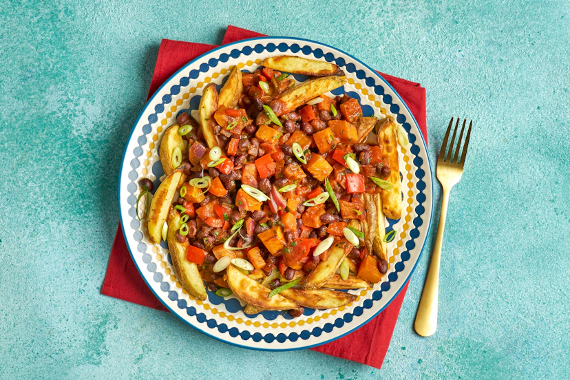 Get a load of this: a lightly spiced chilli of roasted butternut squash and black beans, simmered with onions and peppers in a garlicky tomato sauce – the perfect topping for potato wedges dusted with more spice. A sprinkling of coriander and spring onions and that’s supper sorted.
