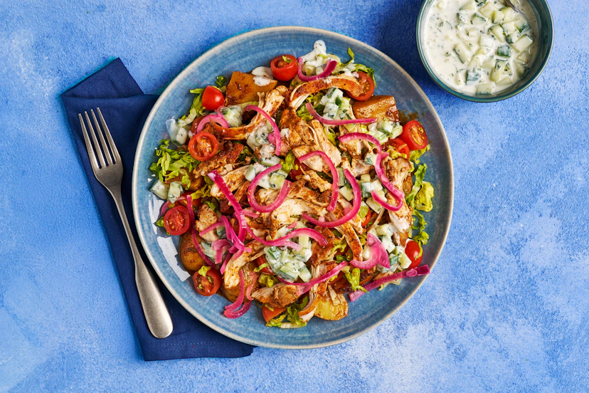 We’ve taken a maximalist approach to this Friday-night fave. Baby potatoes and tender chicken thighs mingle with cumin, smoky paprika and oregano in a super-hot oven, then layer up with crisp salad and cooling tzatziki. Just add quick-pickled onions for big flavour and feel-good vibes!