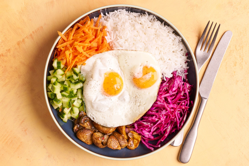 This Technicolor taste of Korean culture is bright, light and ready in 20 minutes flat! Mushrooms simmer in gochujang, tamari, ginger and garlic, then line up alongside quick-pickled cabbage, carrot, cucumber and fluffy rice. Sunny-side-up fried eggs seal the deal – wow!