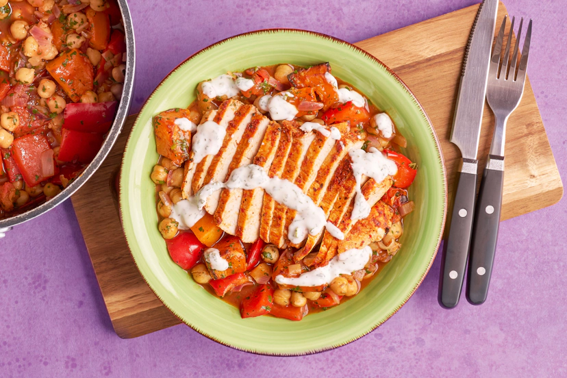 Harissa-rubbed pork medallions, smoky paprika-dusted squash and a rich, slurpy base of herby chickpeas, red peppers and tomatoes – this dish already has plenty to say. Add a dollop of mint and coriander-spiked yogurt and it's singing from the rooftops!