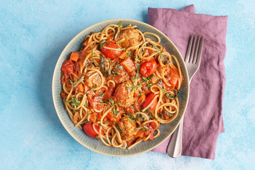 Pork and anise-like fennel are tried-and-tested flavour friends in Italian cuisine – and they bring out the best in each other here. Juicy pork meatballs infused with garlic and fennel seeds are simmered in a rich tomato, basil and fennel-spiked sauce with spinach and carrots. A tangle of spaghetti helps you slurp it all up!