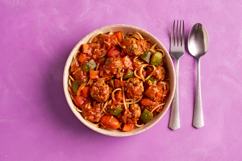 Switch up suppertime with triple the tomato power of your standard spag! Sizzle onions, carrots and courgettes, then add baby toms, our special sun-dried tomato paste and passata to sauce up easy-peasy garlicky turkey meatballs. Ramp up the flavour with balsamic and chilli, and finish with a flash under the grill. Serve with spaghetti for serious satisfaction!