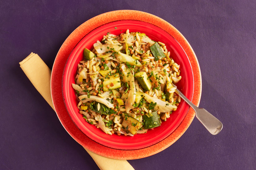 Orzo pasta is the perfect partner for summer veg, magically mingling to bring a medley of flavours to each forkful. It’s teamed with fennel, leek and courgette, sautéed with garlic then zhuzhed up with our garlic, basil & parsley paste and ready-to-use lentils. A quick scattering of fresh tarragon and parsley and – hey presto! – dinner’s done in 30!