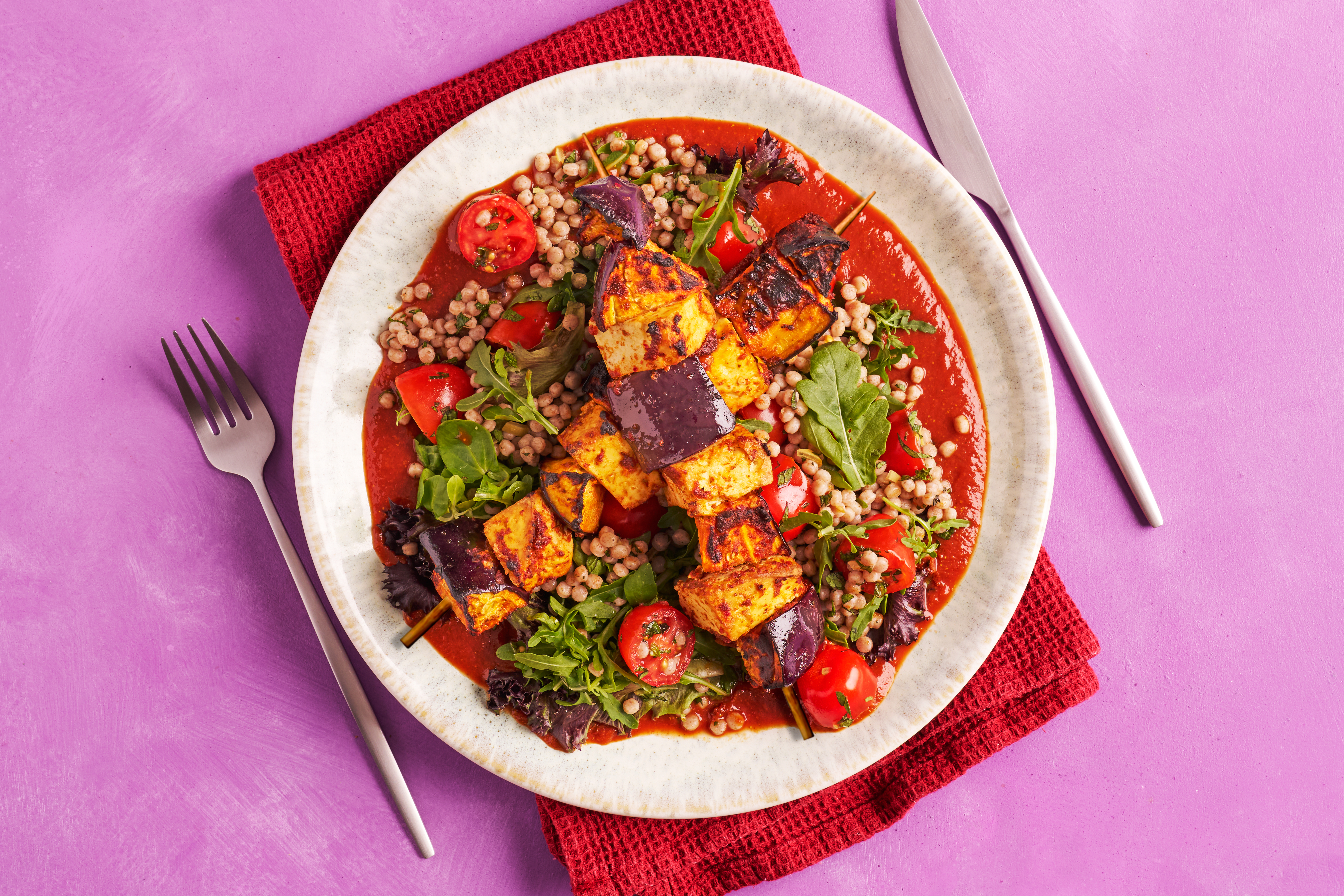 Harissa-spiced tofu skewers & giant couscous